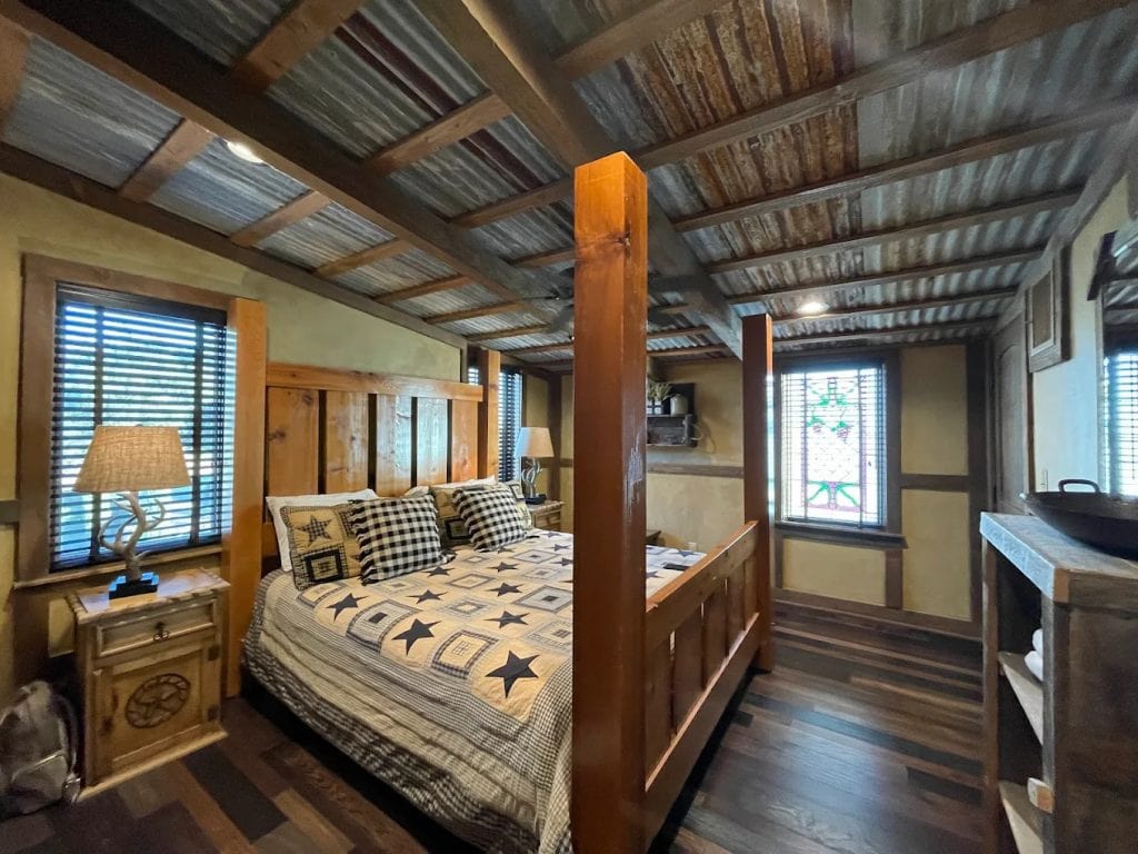 Inside the Brazos Cottage, a grand four-poster king bed and wooden interiors create a spacious, comfortable escape. Credit: Valentina Uzcategui