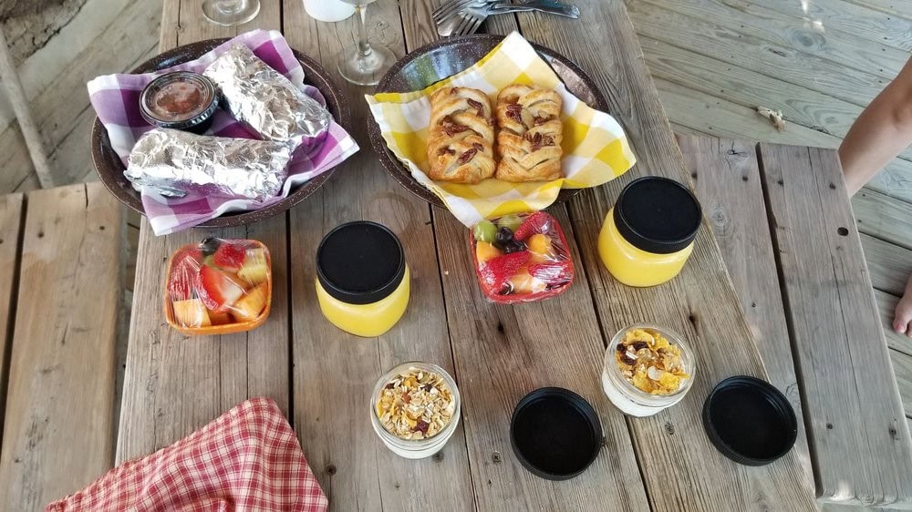 Hot breakfasts include orange juice, oats, pastries, burritos, and fresh fruits—different each day for variety and delight. Credit: Tortious T.