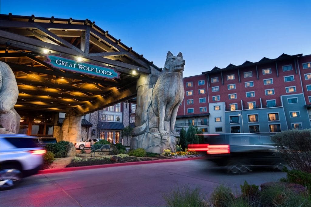 The entrance of Great Wolf Lodge features two towering wolf statues, welcoming guests with a grand woodland vibe. Credit: Great Wolf Lodge | Grapevine