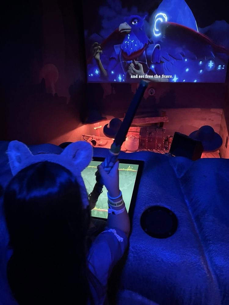 A child enjoys MagiQuest, the lodge’s interactive adventure game that brings imagination to life. Credit: Yannira C.