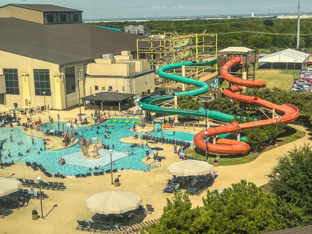 An aerial view of the outdoor pool reveals two massive twisting slides, surrounded by lounge chairs and tables. Credit: Nikki Taylor