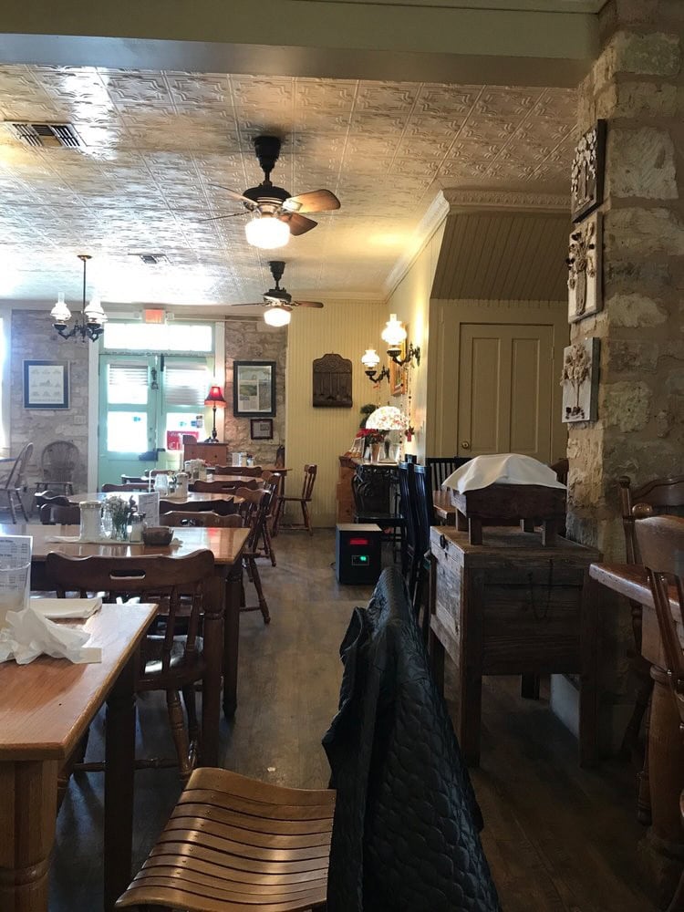 Inside Der Lindenbaum, the cozy traditional German interior features rustic European touches, warm lighting, and wood accents. Credit: Camila C.