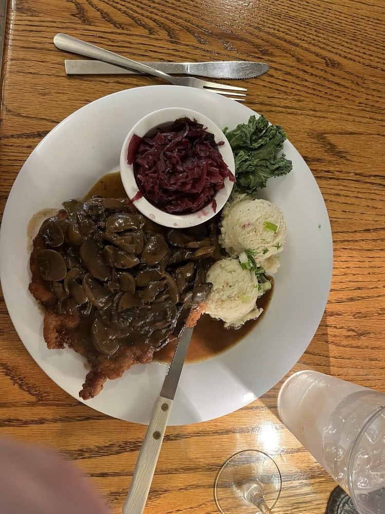 Jäger Schnitzel with mushroom gravy and red cabbage delivers rich, comforting flavor. Credit: Suzanne G.