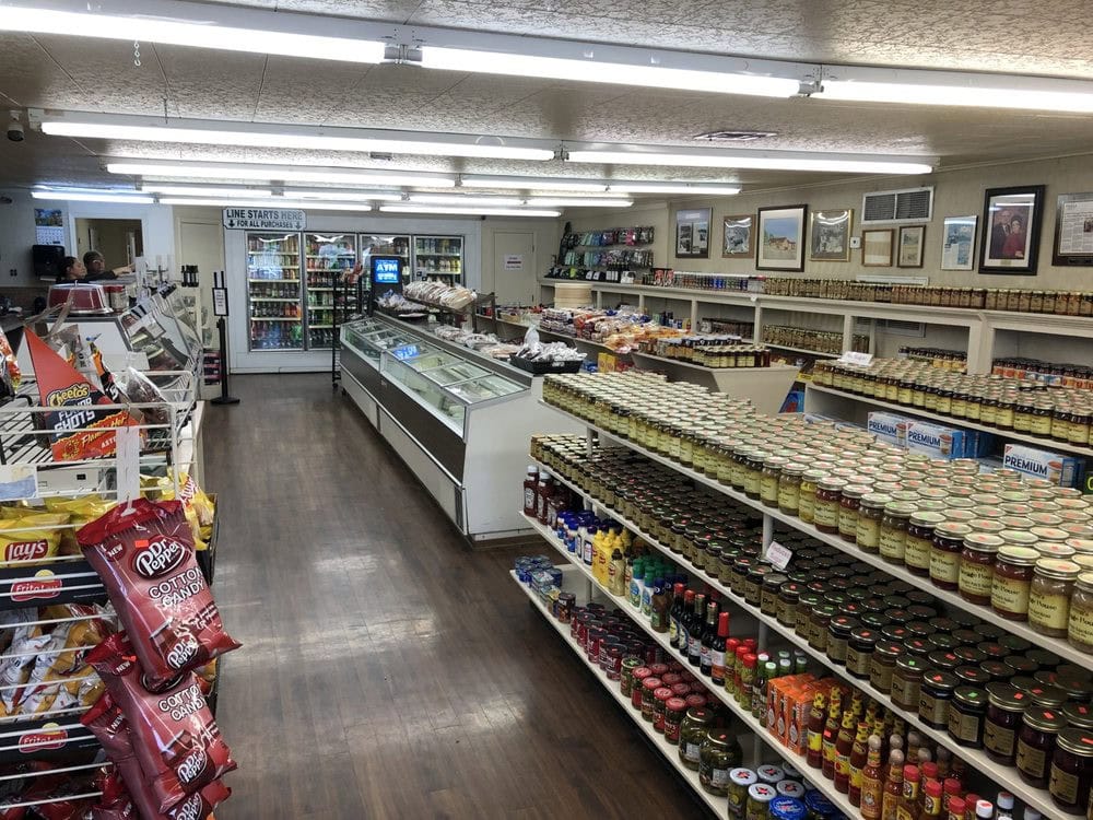 Inside Green’s Sausage House, the meat counter sits to the left, frozen items and bread racks center, with aisles full of jams and specialty goods. Credit: John B.