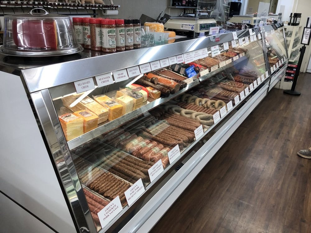 The display case showcases meats, cheeses, and sausages—some ready to eat and clearly marked. Credit: John B.