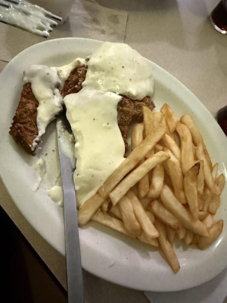 The chicken fried steak, served with gravy and fries, proves Green’s also excels at hearty meals. Credit: Cassie H.