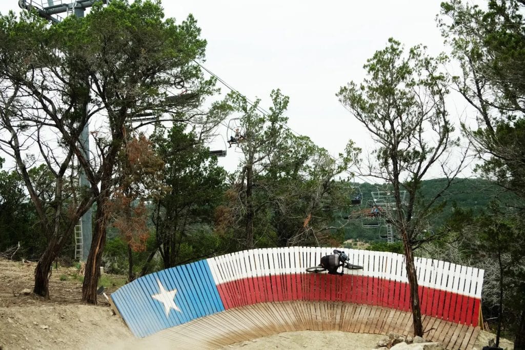 The Tarantula Trail features a wooden wall ride, adding excitement to the course. Credit: Spider Mountain Bike Park