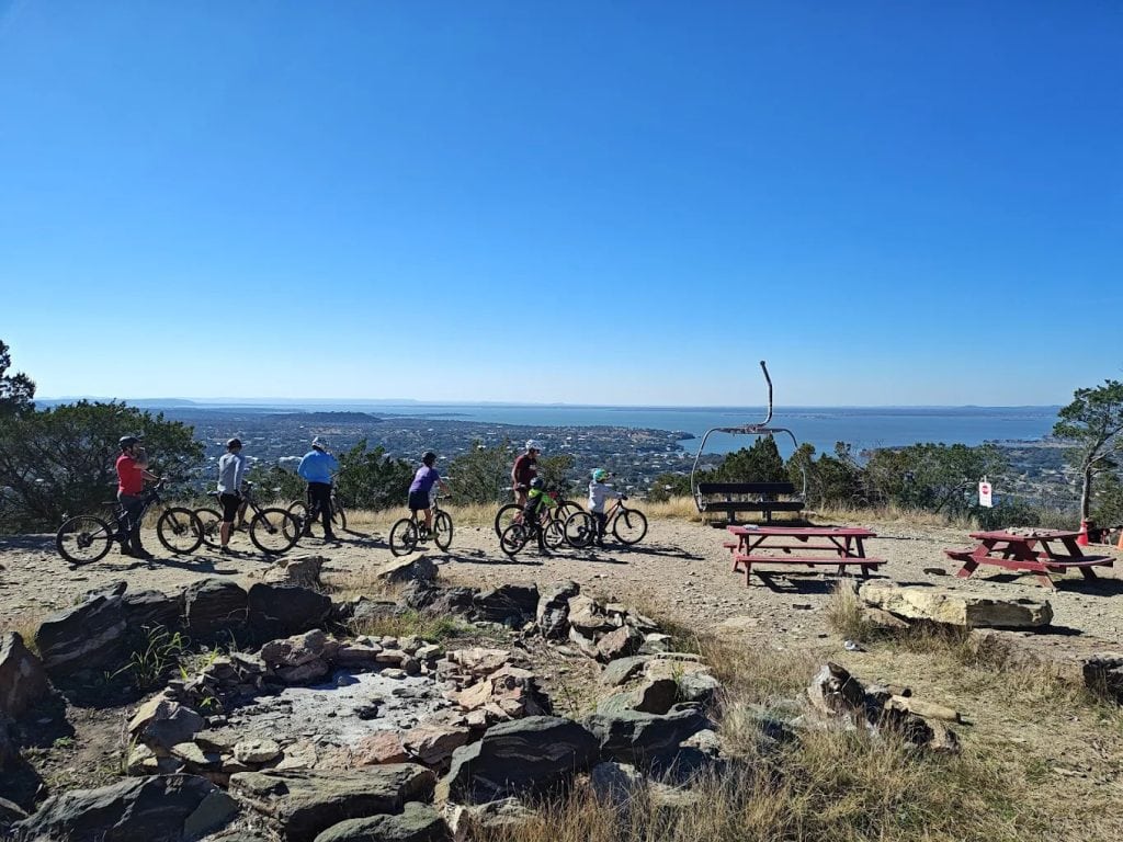 Groups of bikers gather at the summit, enjoying picnic tables and panoramic views of Lake Buchanan. Credit: Scott Ballard