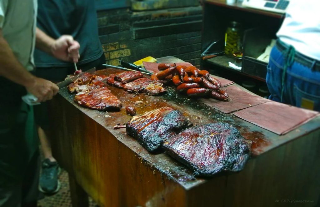 Inside the pit room, pitmasters prepare brisket, sausages, and ribs right before your eyes. Credit: Scott Sandlin