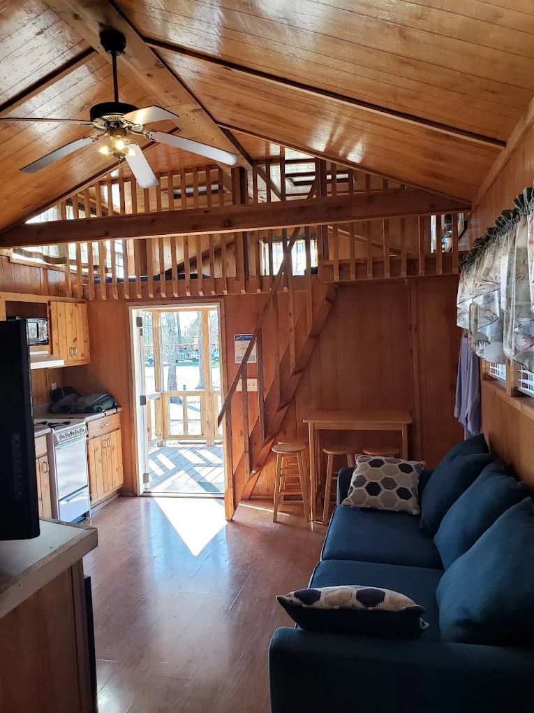 Inside the cabins, wooden interiors, full amenities, a loft sleeping area, and a patio make for a comfortable stay. Credit: Joe Sullivan