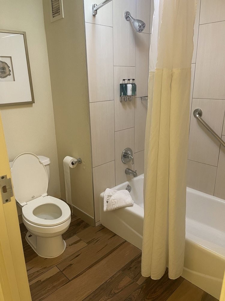 Bathrooms include bathtubs and complete amenities, kept spotless for guest comfort. Credit: Olga K.