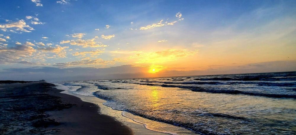 Sunrise over the beach paints the park in golden light, a breathtaking start to the day. Credit: Kathy M.
