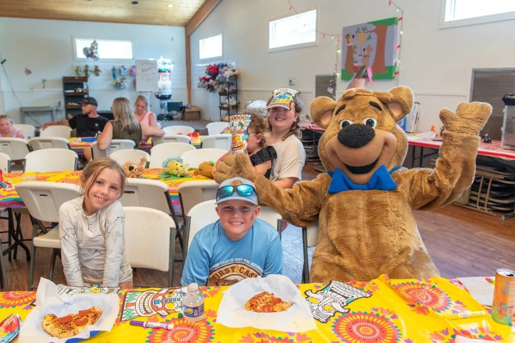 Yogi Bear himself interacts with kids at Jellystone, bringing smiles and unforgettable memories. Credit: Jellystone Park™ Waller Denys