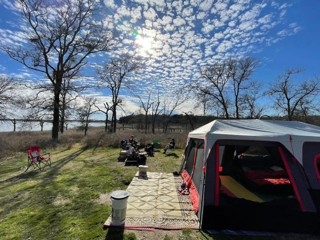 Campsites near the lake are surrounded by trees, perfect for setting up tents and enjoying the outdoors. Credit: Tom Herald
