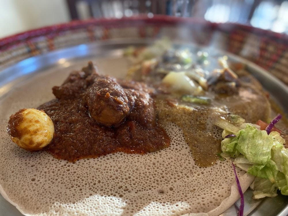 Doro Wat, the signature chicken dish in berbere-based sauce, is a must-try. Credit: Sara W.