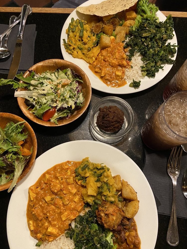 A table spread from the buffet includes Indian recipes, salad, and bread pudding for dessert. Credit: Shawna B.