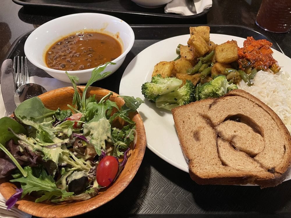 Black bean curry and potatoes with green beans are standout dishes, served with salad, bread, rice, and broccoli. Credit: Liz C.