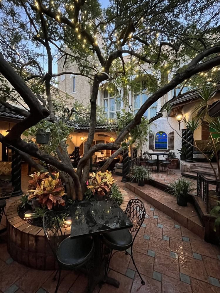 The patio courtyard features a large tree centerpiece, where most guests choose to dine on nice or even cloudy days. Credit: Roshi M.