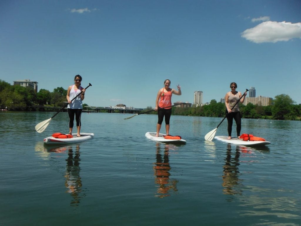 A group of women paddle boarding together brings energy and fun to the calm waters. Credit: ￼Live Love Paddle
