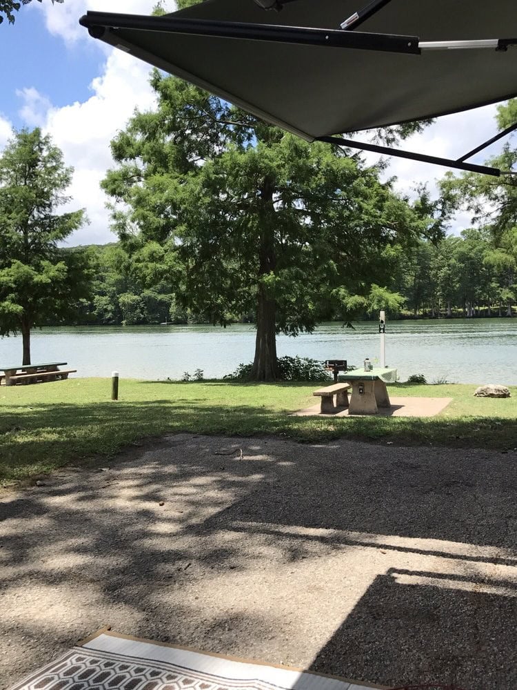 Lakeside picnic tables set the stage for relaxed gatherings and scenic outdoor meals. Credit: Marion W.