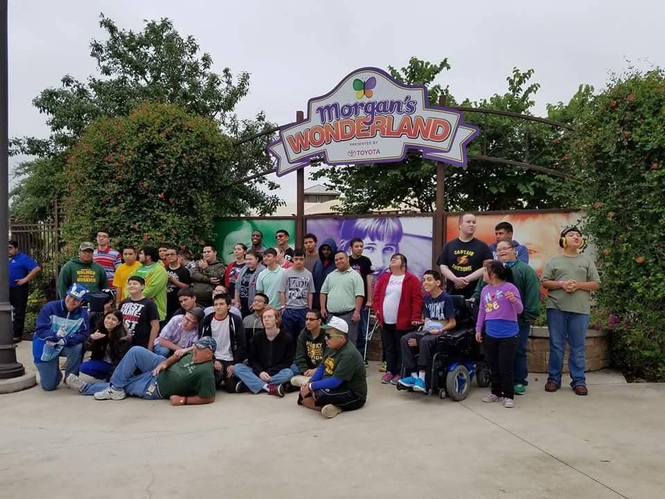 Differently abled children pose for a group photo at the Morgan’s Wonderland sign, a joyful reminder that everyone belongs. Credit: Art Ledbetter M.