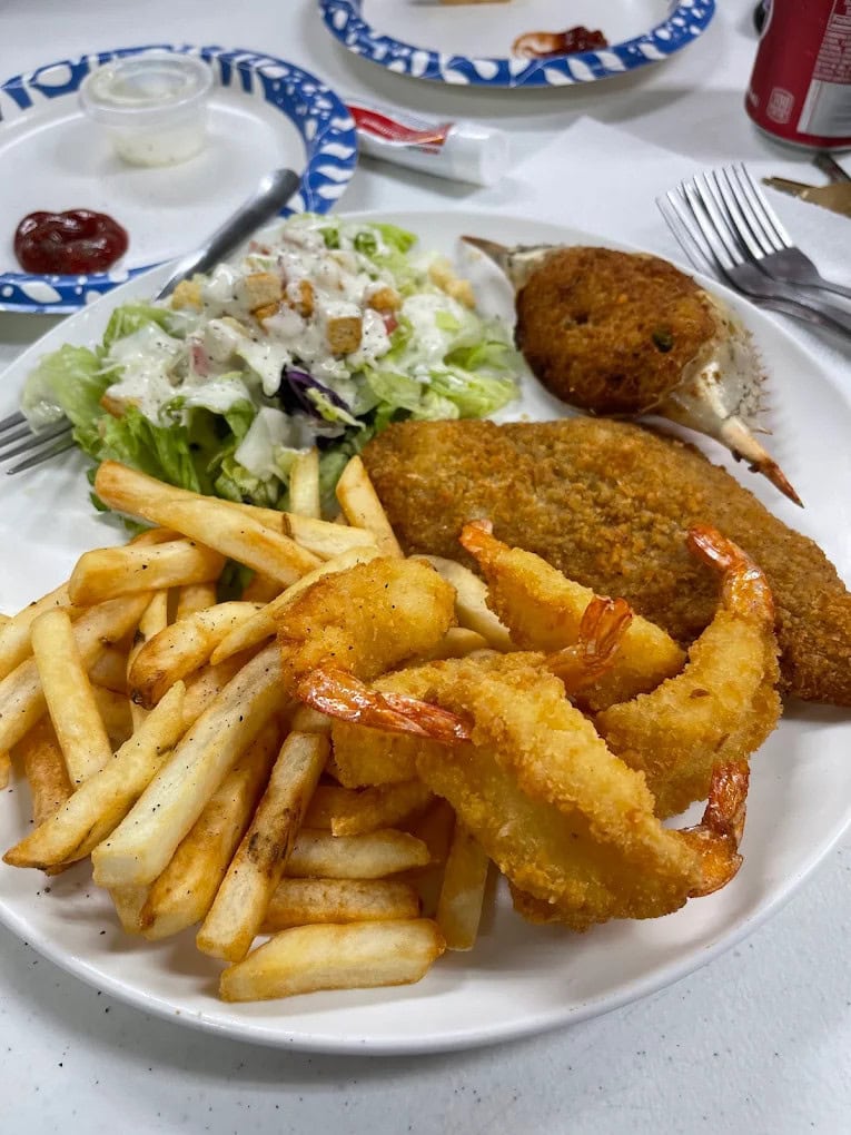 Marty’s Landing and Mama’s Kitchen serve up a seafood platter of fried shrimp, breaded flounder, and stuffed crabs—true coastal comfort food. Credit: Kasandra King