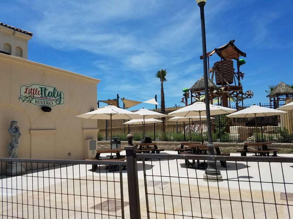 Outdoor tables with umbrellas at Little Italy Bistro provide a welcoming spot to dine and relax at the resort. Credit: Kirsten W.