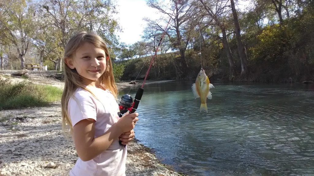 A girl catches a small fish at Don’s Fish Camp, proving the name lives up to its promise. Credit: Cody Sherwood