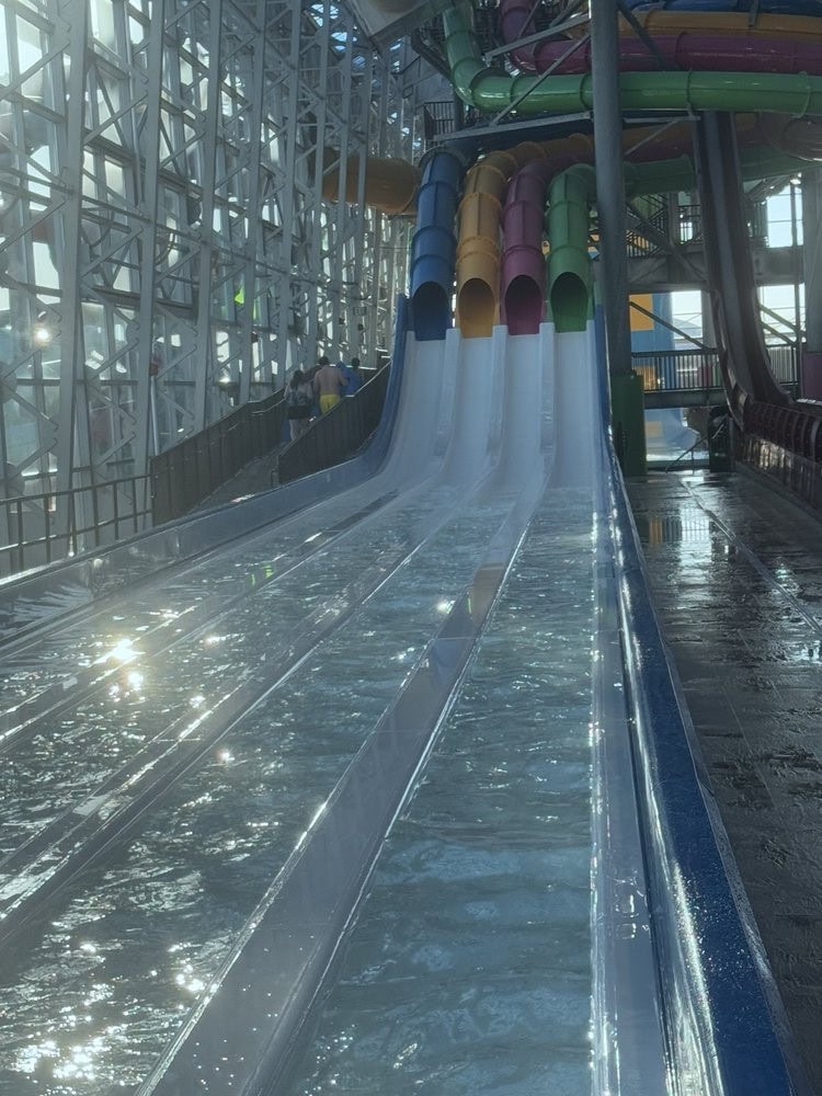 The E‑Racer slide pits four riders head‑to‑head on mat slides for a thrilling race downward. Credit: Tank G.