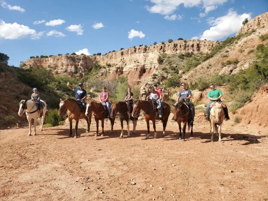 Groups of tourists and locals ride horseback through Palo Duro Canyon, experiencing the rugged beauty up close. Credit: Nathaniel Estrada