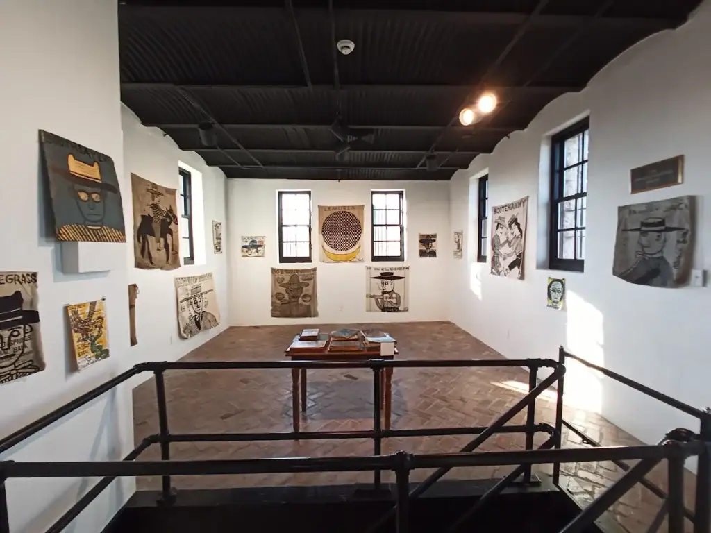 Cowboy and Texas-themed artworks inside the Old Jail Art Center — one of many rotating exhibits spanning Western heritage to modern pieces. Credit: John Heddrick