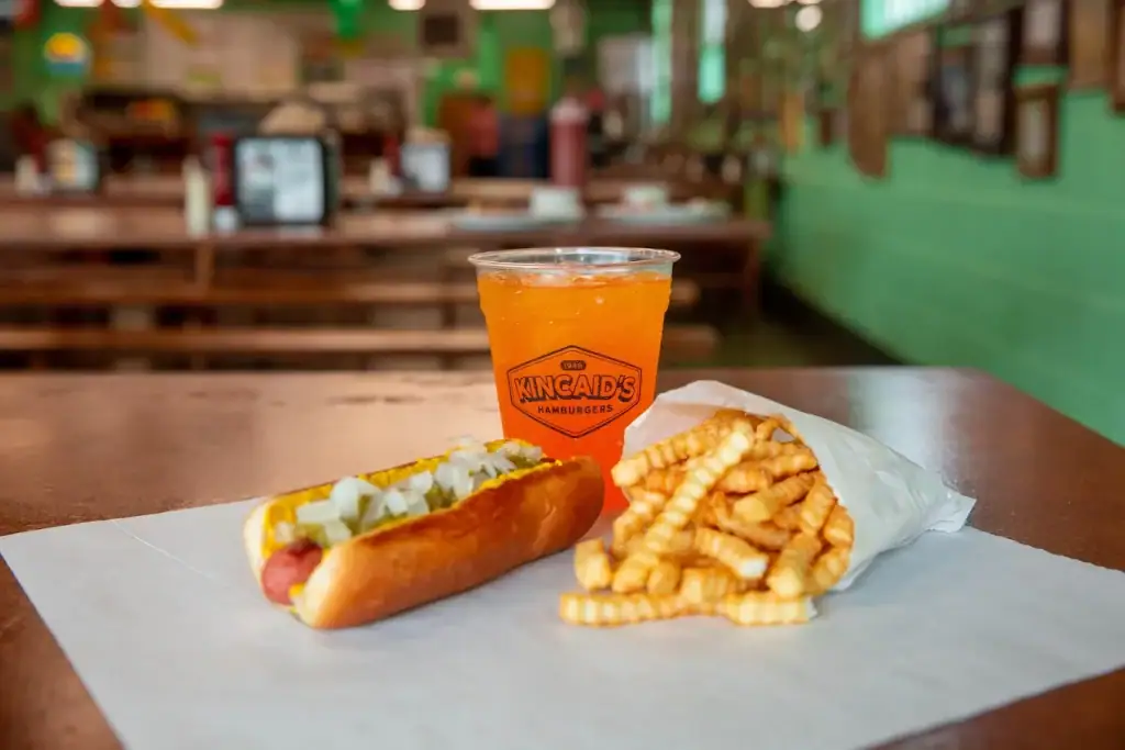 Kincaid’s hotdog comes loaded with timeless toppings like onions, mustard, and pickles. Credit: Kincaid's Hamburgers