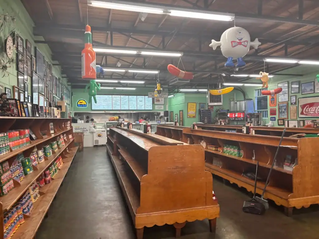 Inside Kincaid’s feels like stepping back in time, with old-school grocery shelves, framed memories, and a counter menu at the far end. Credit: Mubeen Kamani