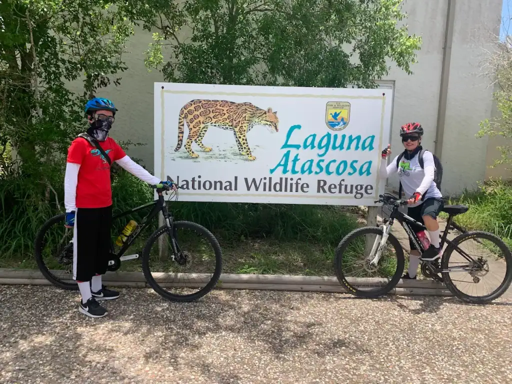 Visitors pose with the Laguna Atascosa signage, proudly showcasing illustrated ocelots cared for at the refuge. Credit: Joshua De la Hoz