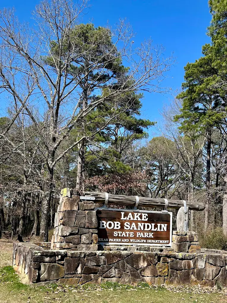 Entrance sign of Lake Bob Sandlin State Park welcoming you into a quiet escape of pine forests and shoreline views. Credit: Kay Lynn