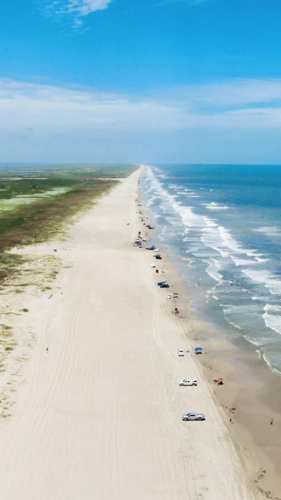 An aerial view of miles of Matagorda Beach featuring clean sand, untouched nature, and clear blue water. Credit: Juvy J. Green via Facebook