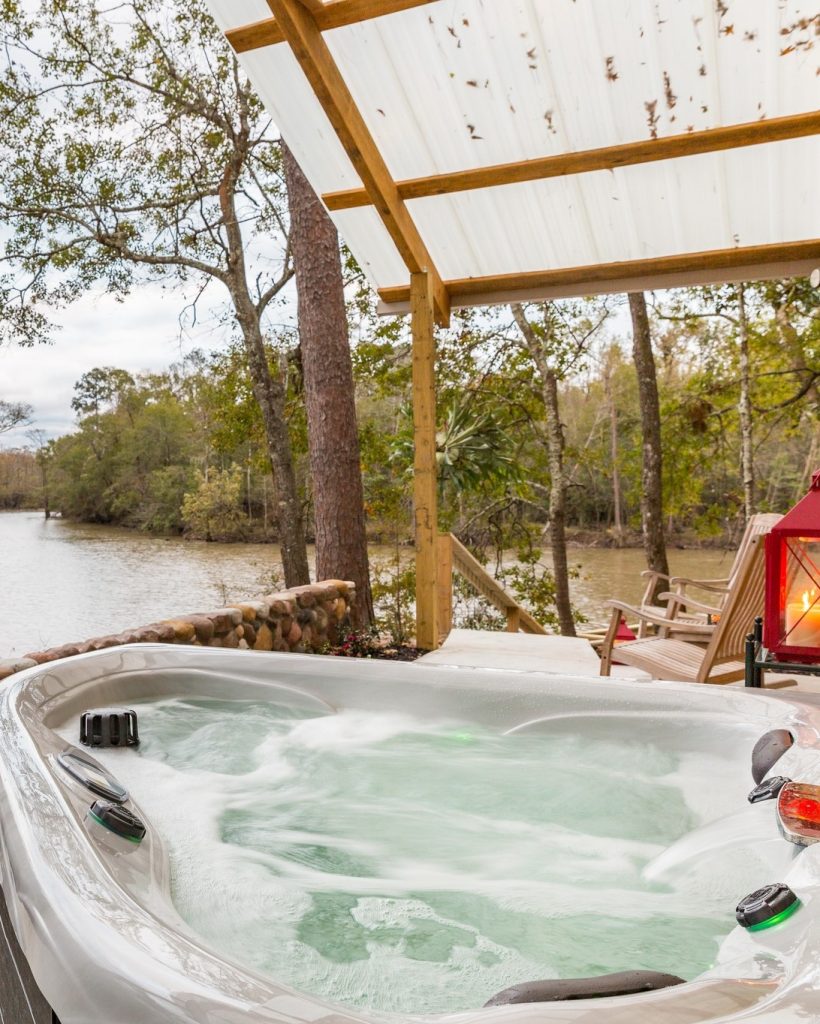 A private outdoor soaking tub at Naturalist Boudoir Cabins, where guests can relax under the open sky in complete privacy. Credit: @naturalistboudoir via Instagram