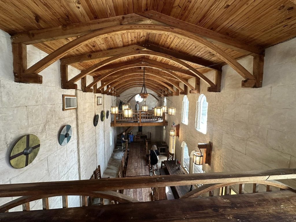 Inside the castle’s great hall: soaring wooden ceilings, long tables, and craftsmanship that feels truly medieval. Credit: Casey Carmichael via Facebook
