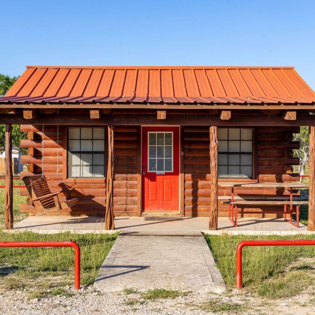 A cozy cabin at the resort featuring a porch, swing, and outdoor dining area—ideal for guests who prefer comfort over tent camping. Credit: @nuecesriverrv via Instagram