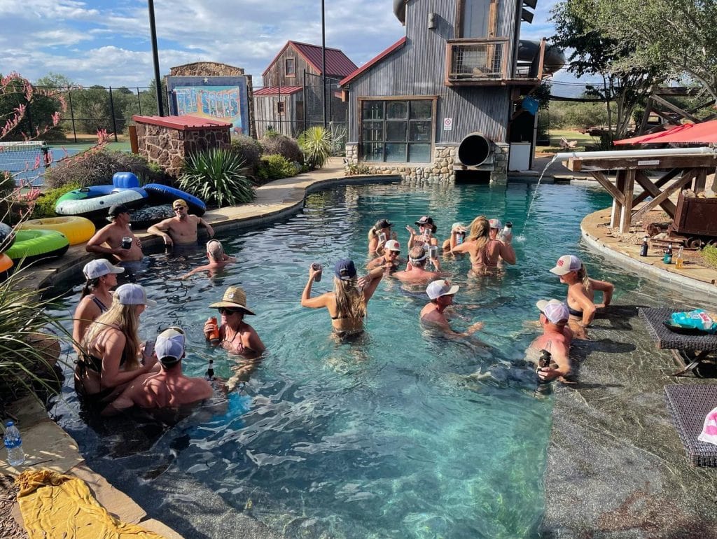 Guests enjoying a lively pool party at Red Sands Ranch—sun, water, and great company all in one place. Credit: @redsandsranch via Instagram