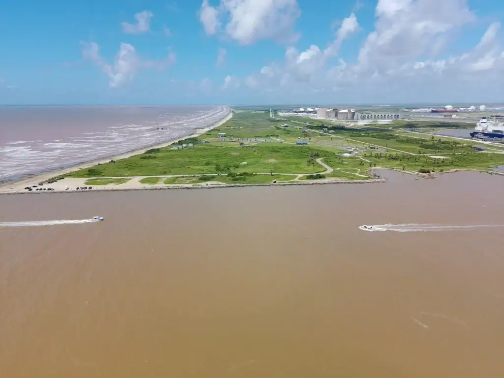 An aerial view of Surfside Beach, Texas reveals endless sandy shores and sparkling waves along the Gulf. Credit: Todd Williams