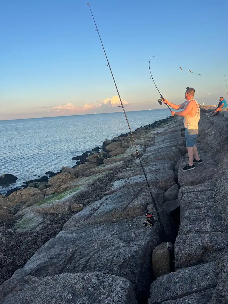 Fishing by the docks at Surfside Beach brings relaxation, fresh catches, and a taste of coastal life. Credit: Elizabeth Fletcher