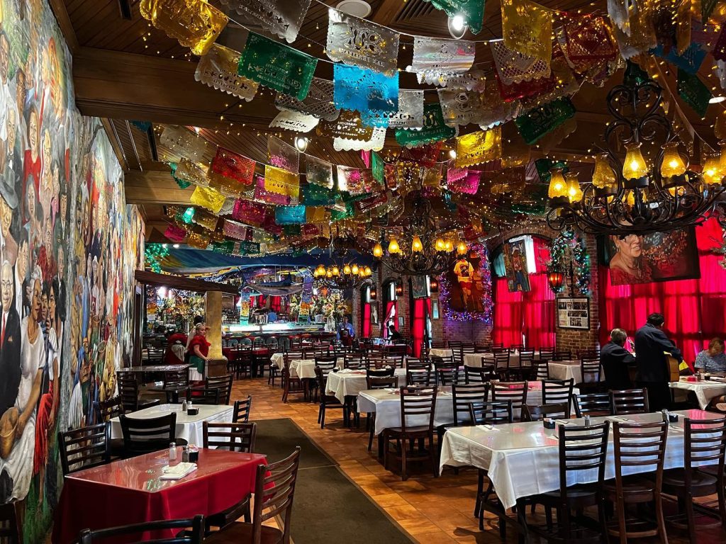 Inside Mi Tierra Café y Panadería, where festive décor, colorful lights, and nonstop energy make it a feast for the eyes as much as the food. Credit: @actionkidtv via Instagram