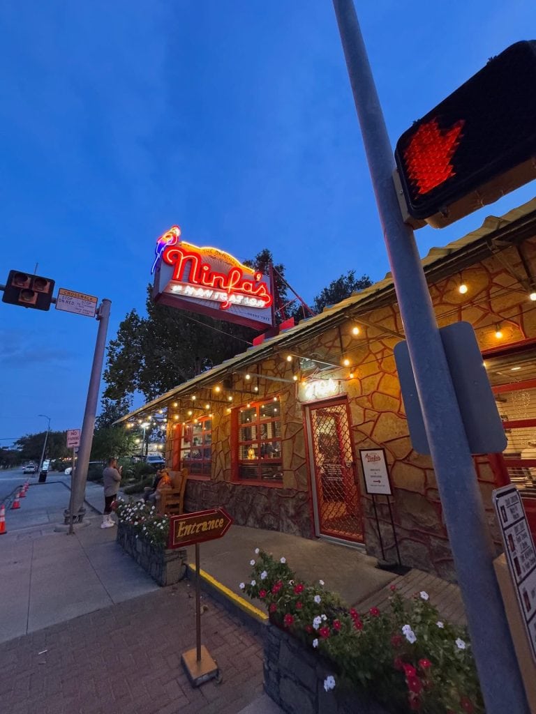 The iconic façade of The Original Ninfa’s on Navigation, marked by its glowing red neon sign and warm, inviting outdoor lights. Credit: @explorewithomar via Instagram