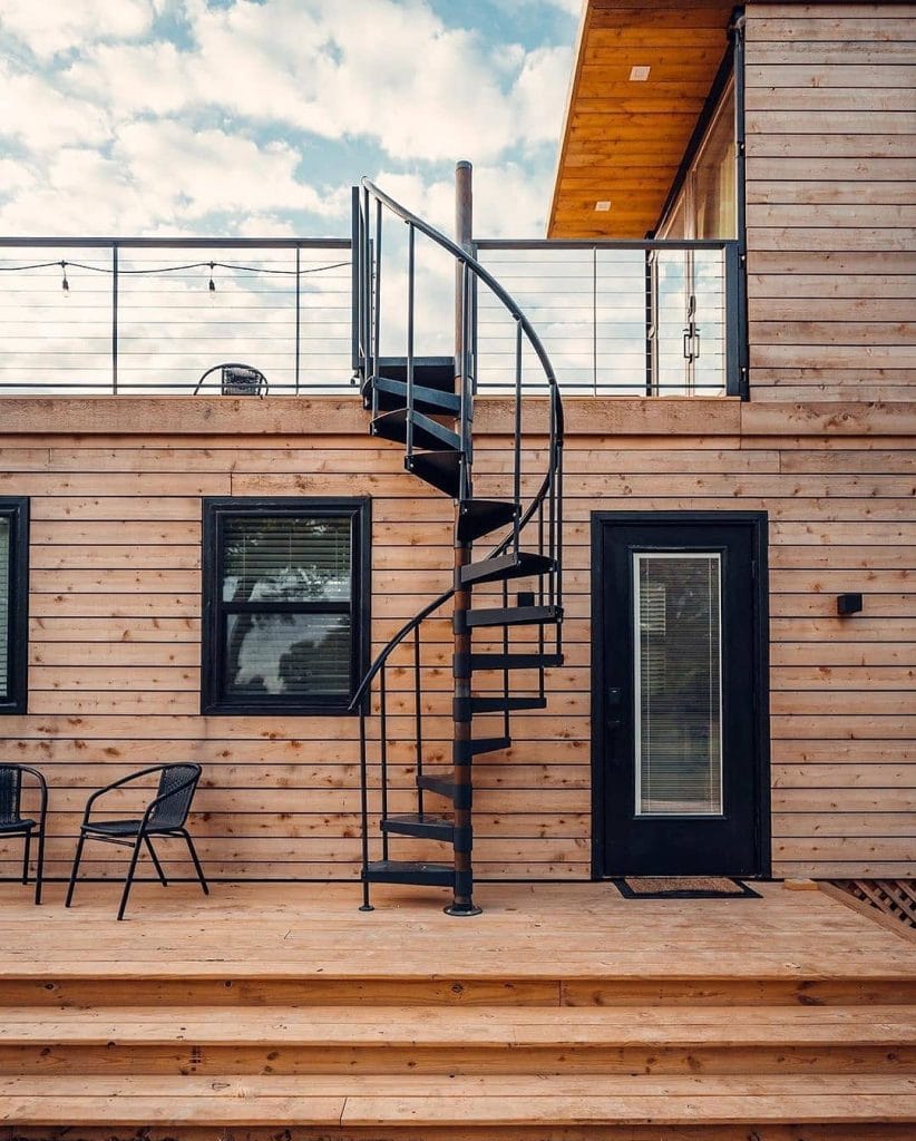 Stairs leading up to the second floor and rooftop deck of The Helm — clean lines, modern design, and that subtle anticipation of what the view’s going to look like once you reach the top. Credit: @tinyhouseperfect via Instagram