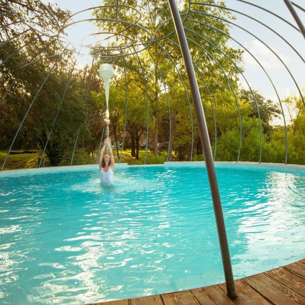 The lakeside pool at Cypress Valley is one of the many outdoor amenities guests can enjoy while glamping in nature. Credit: @cypressvalleytreehouses via Instagram