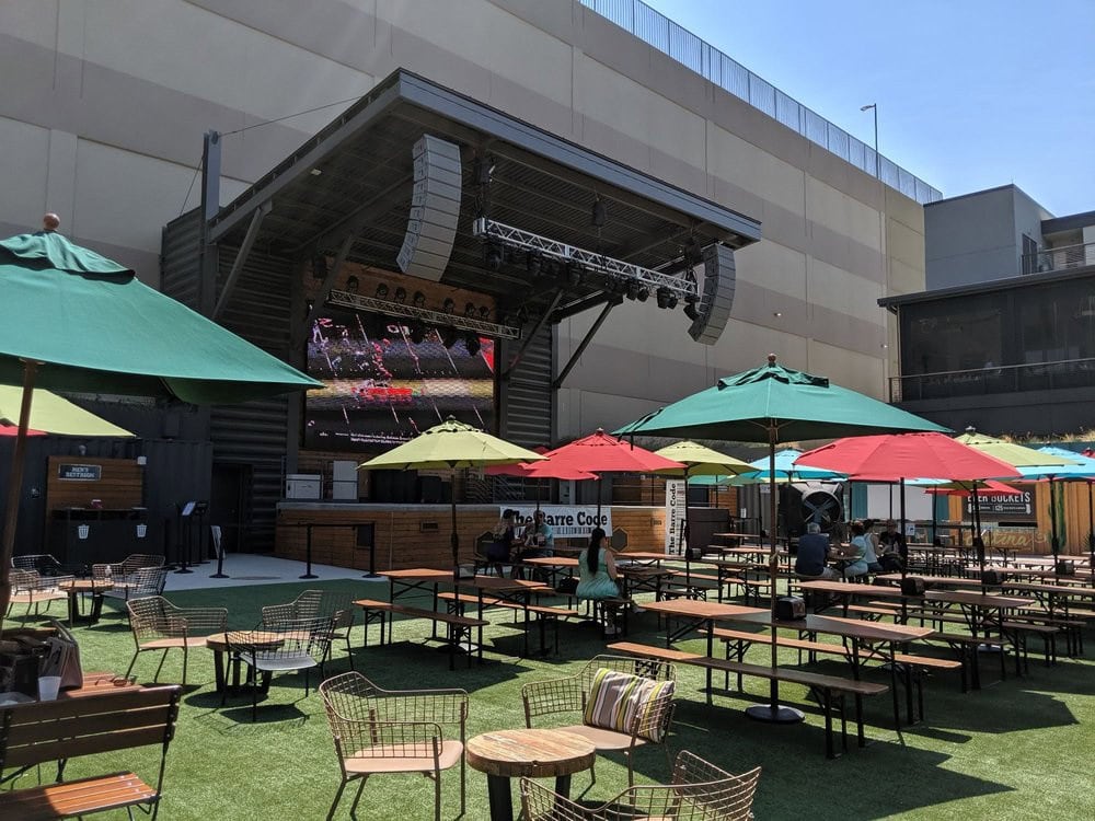 Legacy Hall’s outdoor garden offers huge seating areas with tables, umbrellas, and a large projector screen for gatherings. Credit: Samson L.