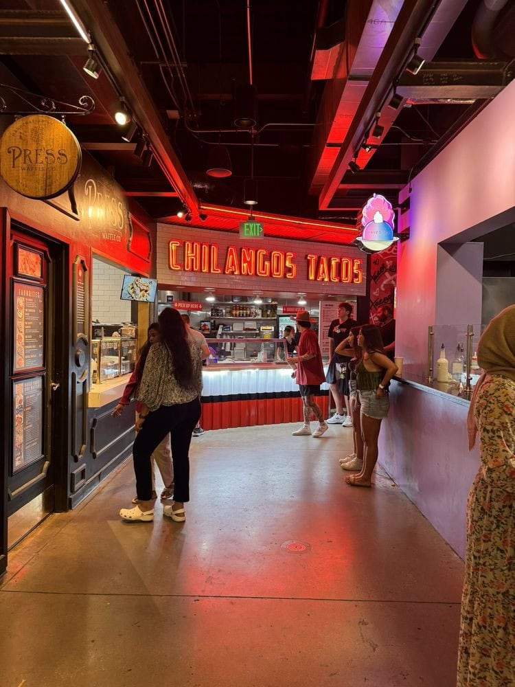 Chilangos Tacos stands out with Mexican design and a red neon sign that draws attention inside Legacy Hall. Credit: Kris B.