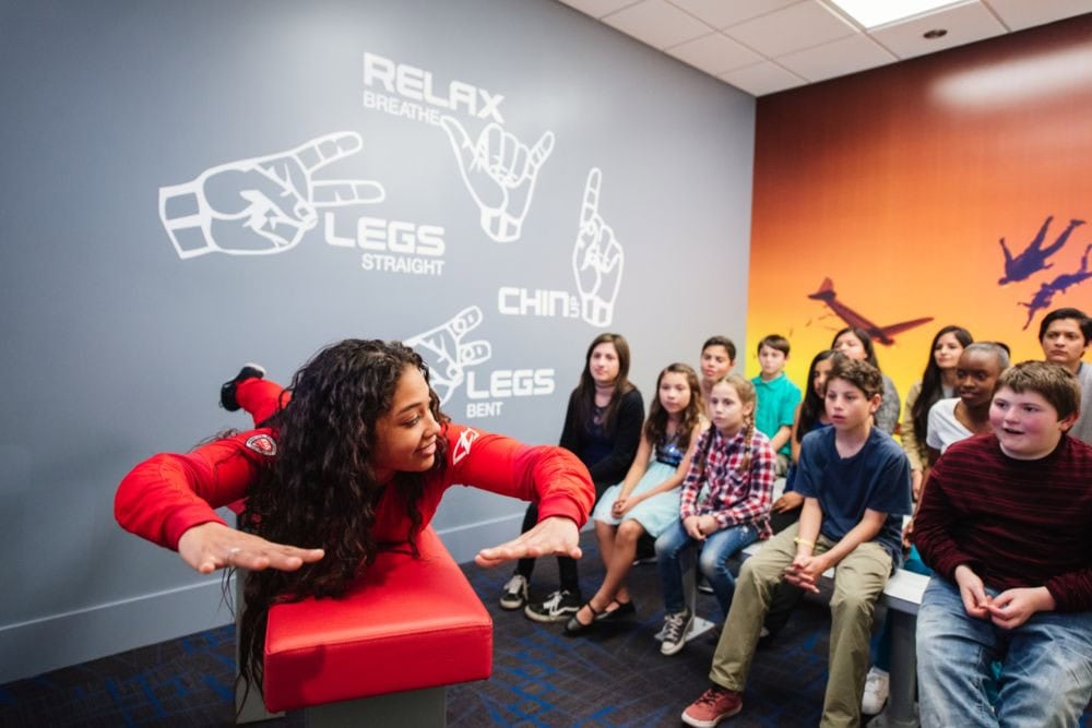 Instructors at iFLY provide lessons and demos before you take flight, ensuring safety and confidence. Credit: iFLY