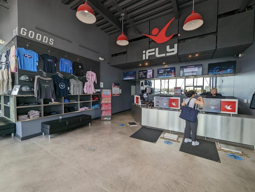 The iFLY lobby has a modern interior with clear package options and merchandise for souvenirs. Credit: Maps Boss